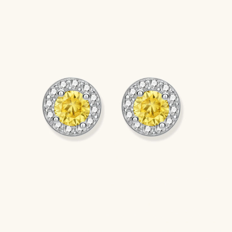 Dainty sterling silver stud earrings with yellow moissanite center stones surrounded by white halo stones