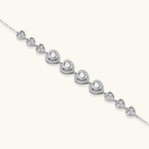Complete jewelry set with heart-shaped sterling silver pieces featuring brilliant moissanite stones on white background.
