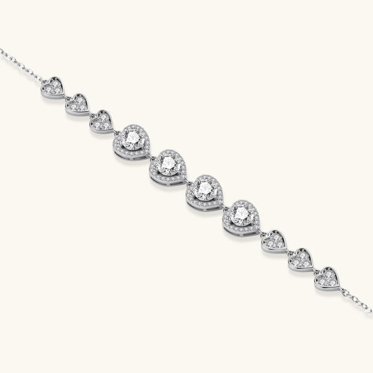 Complete jewelry set with heart-shaped sterling silver pieces featuring brilliant moissanite stones on white background.