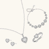 Complete jewelry set with heart-shaped sterling silver pieces featuring brilliant moissanite stones on white background.