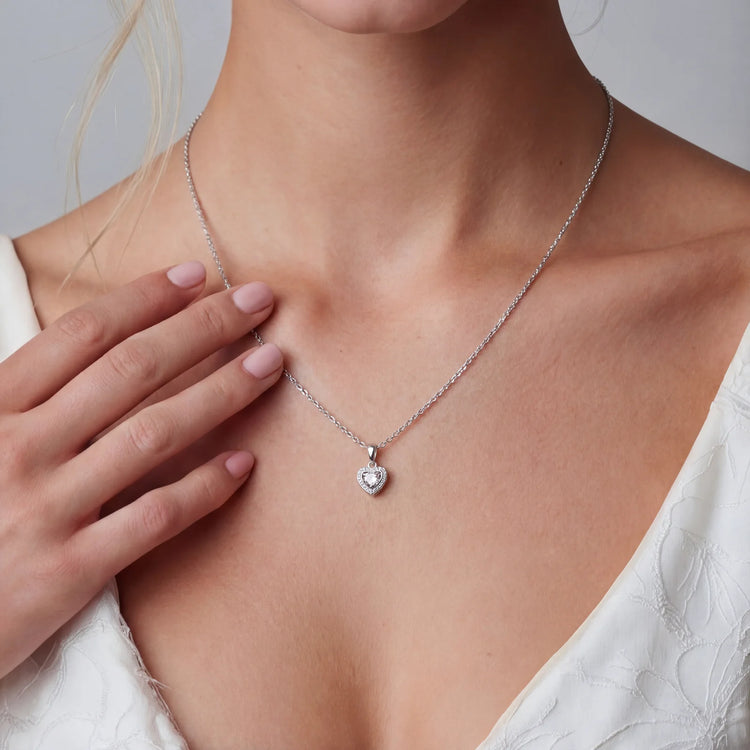 Complete jewelry set with heart-shaped sterling silver pieces featuring brilliant moissanite stones on white background.
