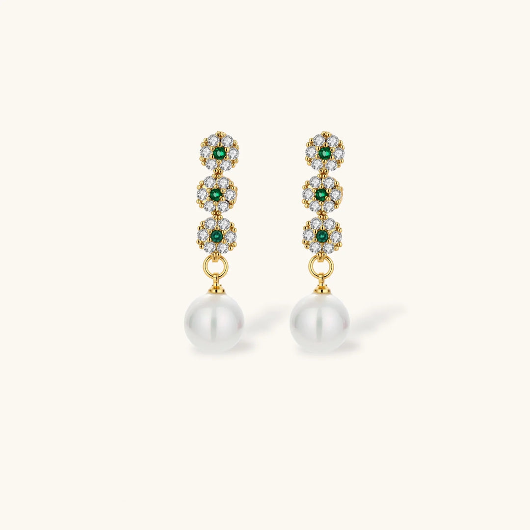 Gold-plated jewelry set with green cubic zirconia floral motifs, featuring matching necklace and pearl drop earrings