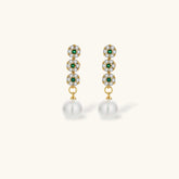 Gold-plated jewelry set with green cubic zirconia floral motifs, featuring matching necklace and pearl drop earrings