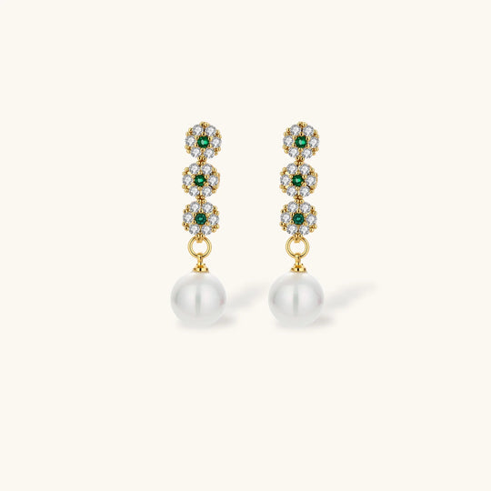 Gold-plated jewelry set with green cubic zirconia floral motifs, featuring matching necklace and pearl drop earrings