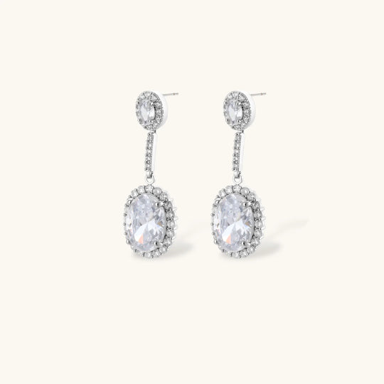 Elegant white gold plated jewelry set with oval cubic zirconia stones in halo settings, featuring Y-necklace and drop earrings.
