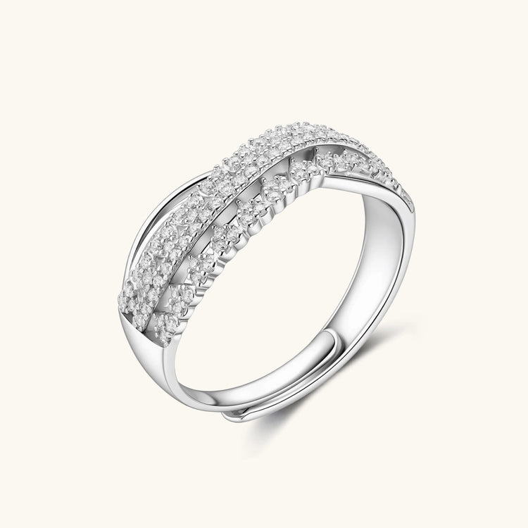 Sterling silver crossover ring with pavé-set moissanite stones creating an elegant infinity design on neutral background