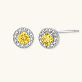 Dainty sterling silver stud earrings with yellow moissanite center stones surrounded by white halo stones