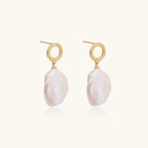 18K gold vermeil twisted circle studs with organic white baroque pearl drops on cream background