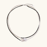 Double-strand necklace with black faceted quartz and white pearls featuring an oversized baroque pearl centerpiece