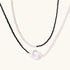 Double-strand necklace with black faceted quartz and white pearls featuring an oversized baroque pearl centerpiece