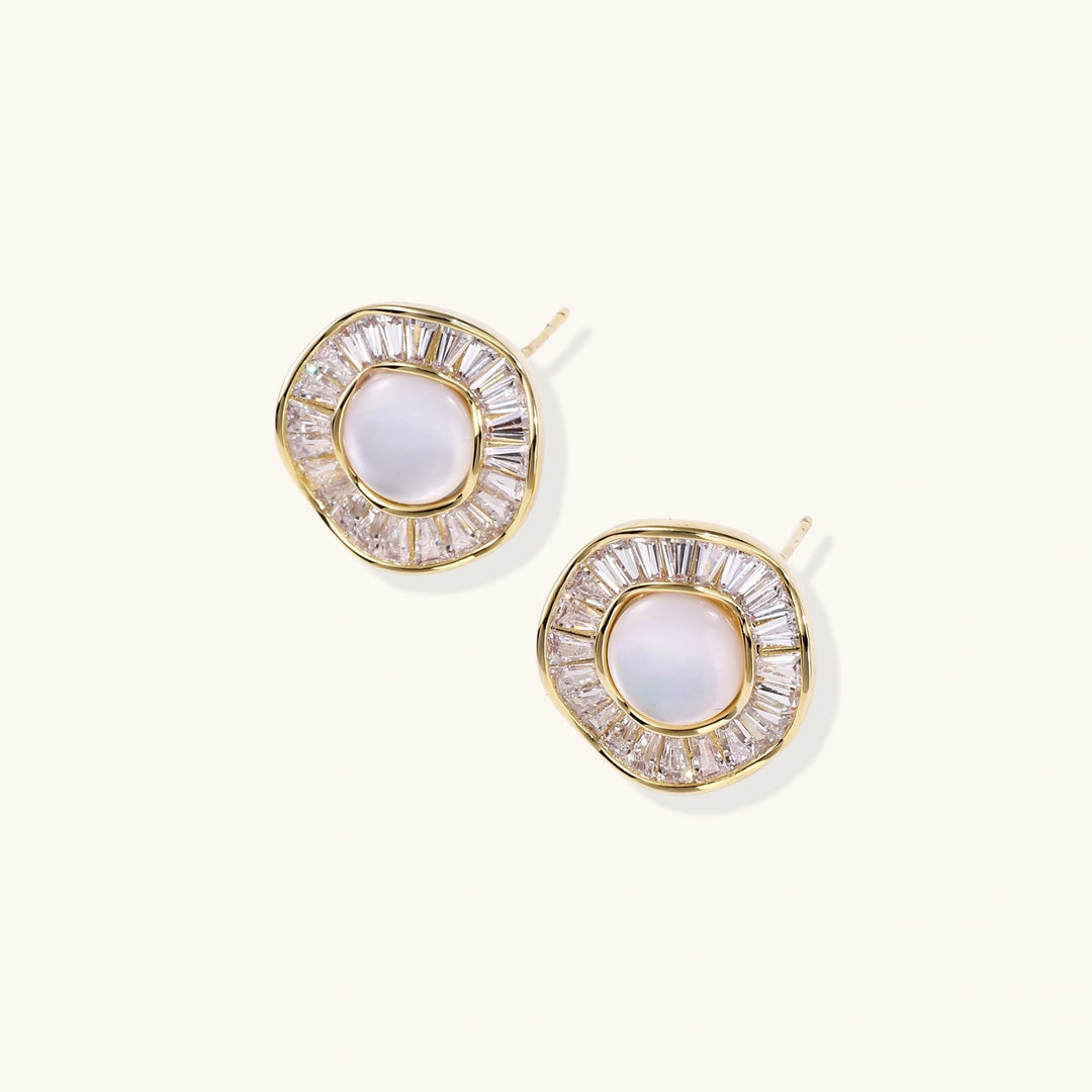 Round 14K gold-plated stud earrings with a mother of pearl center surrounded by baguette-cut crystals, 16mm.