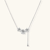 White gold plated Y-shaped necklace with three dimensional flower charms and adjustable drop pendant