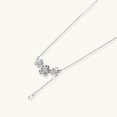 White gold plated Y-shaped necklace with three dimensional flower charms and adjustable drop pendant