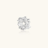 Wide band ring with sculptural wave ripples in polished white gold plated eco-brass on cream background