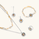 Complete jewelry set featuring citrine stone chips, silver beads, and cosmic circle pendants on cream background.