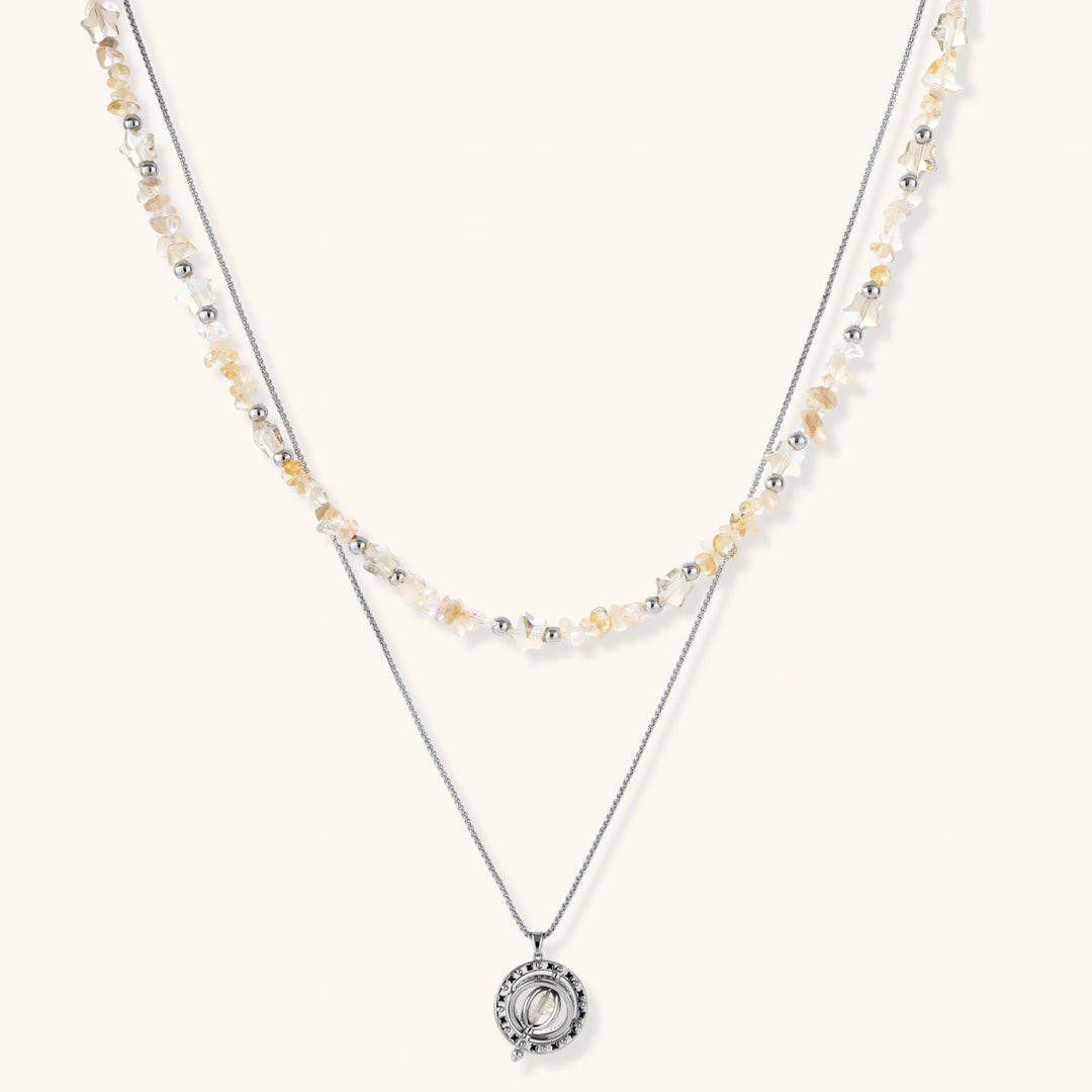 Complete jewelry set featuring citrine stone chips, silver beads, and cosmic circle pendants on cream background.