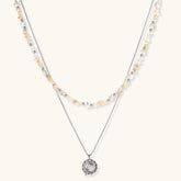 Complete jewelry set featuring citrine stone chips, silver beads, and cosmic circle pendants on cream background.