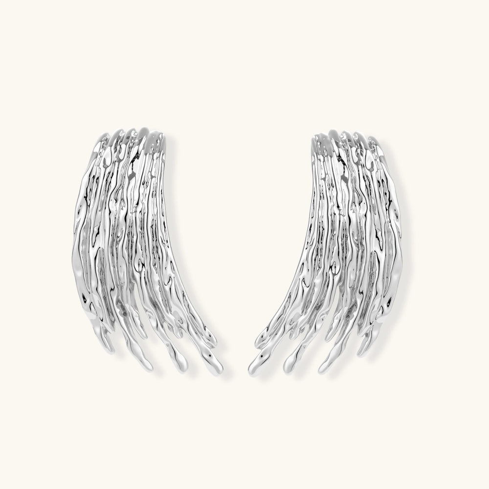 Layered metallic wing-shaped pendant and matching earrings with feathered texture in silver and gold finishes