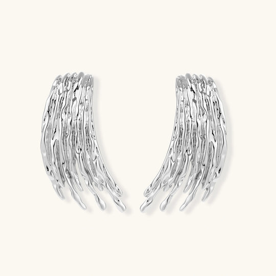 Layered metallic wing-shaped pendant and matching earrings with feathered texture in silver and gold finishes