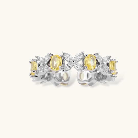 Close-up of platinum-plated copper eternity ring featuring alternating yellow and clear marquise-cut stones in elegant band setting.