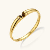 Polished gold bangle with two oval tiger&