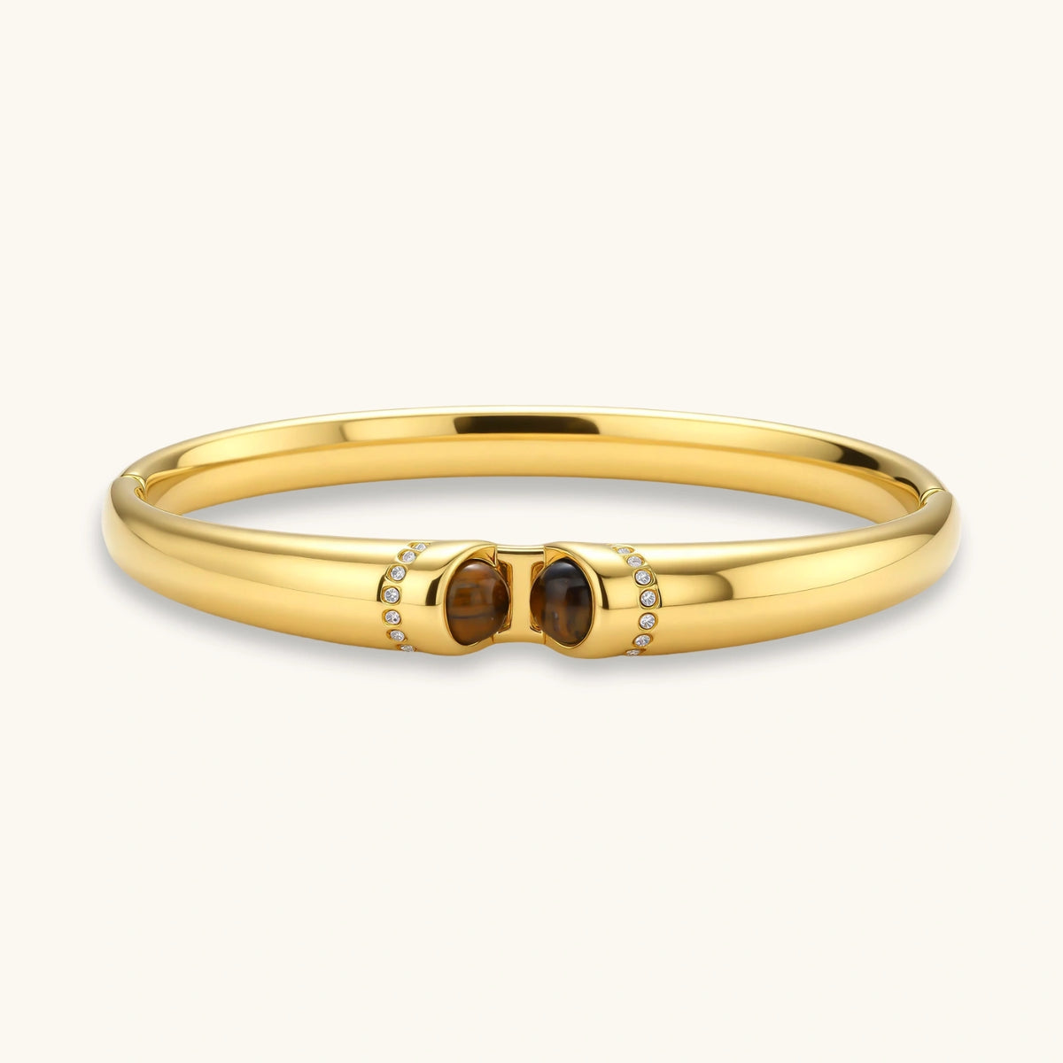 Polished gold bangle with two oval tiger&