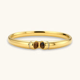 Polished gold bangle with two oval tiger&