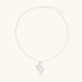 Abstract S-curve sterling silver pendant with zirconia accents on delicate chain against white background